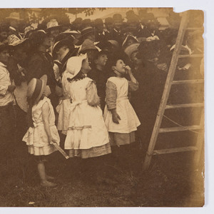 Children crowd around a ladder.